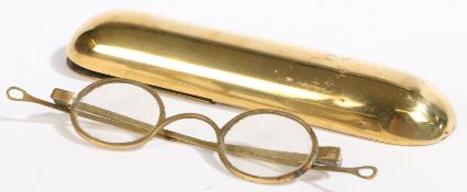A rare 18th century brass spectacle case, with eyeglasses Of tactile, rounded-rectangular form,