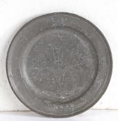 A George I pewter wrigglework plate, circa 1715 Having a single-reed rim, decorated with