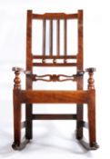 An early 19th century fruitwood, mahogany and alder wood child’s rocking chair, East Anglia, circa