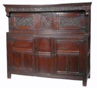 A Charles II joined oak court cupboard, Westmorland, date 1675 The frieze with ball turned end-