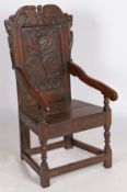 A Charles II oak panel-back open armchair, Yorkshire, circa 1680 The back panel carved with a