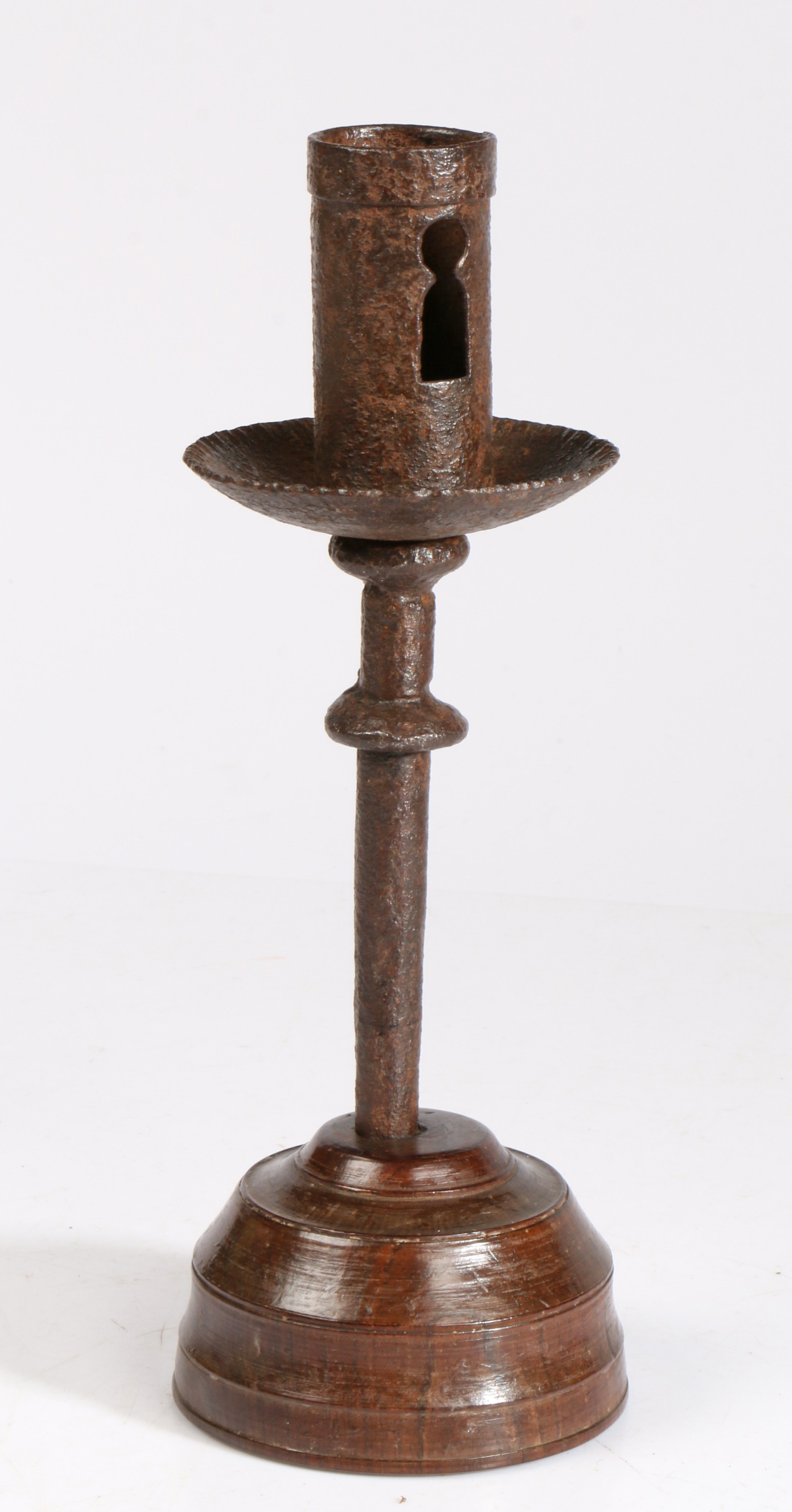 A 16th century iron socket candlestick, on an early 19th century turned lignum vitae base  The