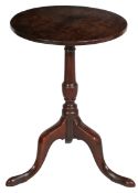 A George III oak wine tripod table, circa 1780 Having a one-piece circular top, on a vase-turned