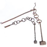 Two iron pot hangers, possibly 17th century Each with a twist-work rod, scroll-over hook end,