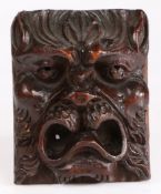 A fruitwood grotesque mask, English, circa 1600-20 With deep-set eyes, pointed ears, and open mouth,