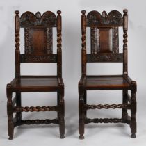 A pair of Charles II oak backstools, Shropshire, circa 1680 Each with a small fielded back panel,