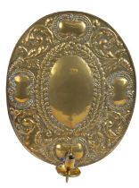 A repousé brass wall sconce, Dutch The oval backplate with a central oval and scrolling leaf
