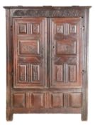 A 17th century oak cupboard, French, dated 1688 The moulded cornice above two panelled doors,