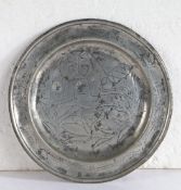 A rare George II pewter wrigglework plate, Hampshire, circa 1735 Having a single reed rim designed