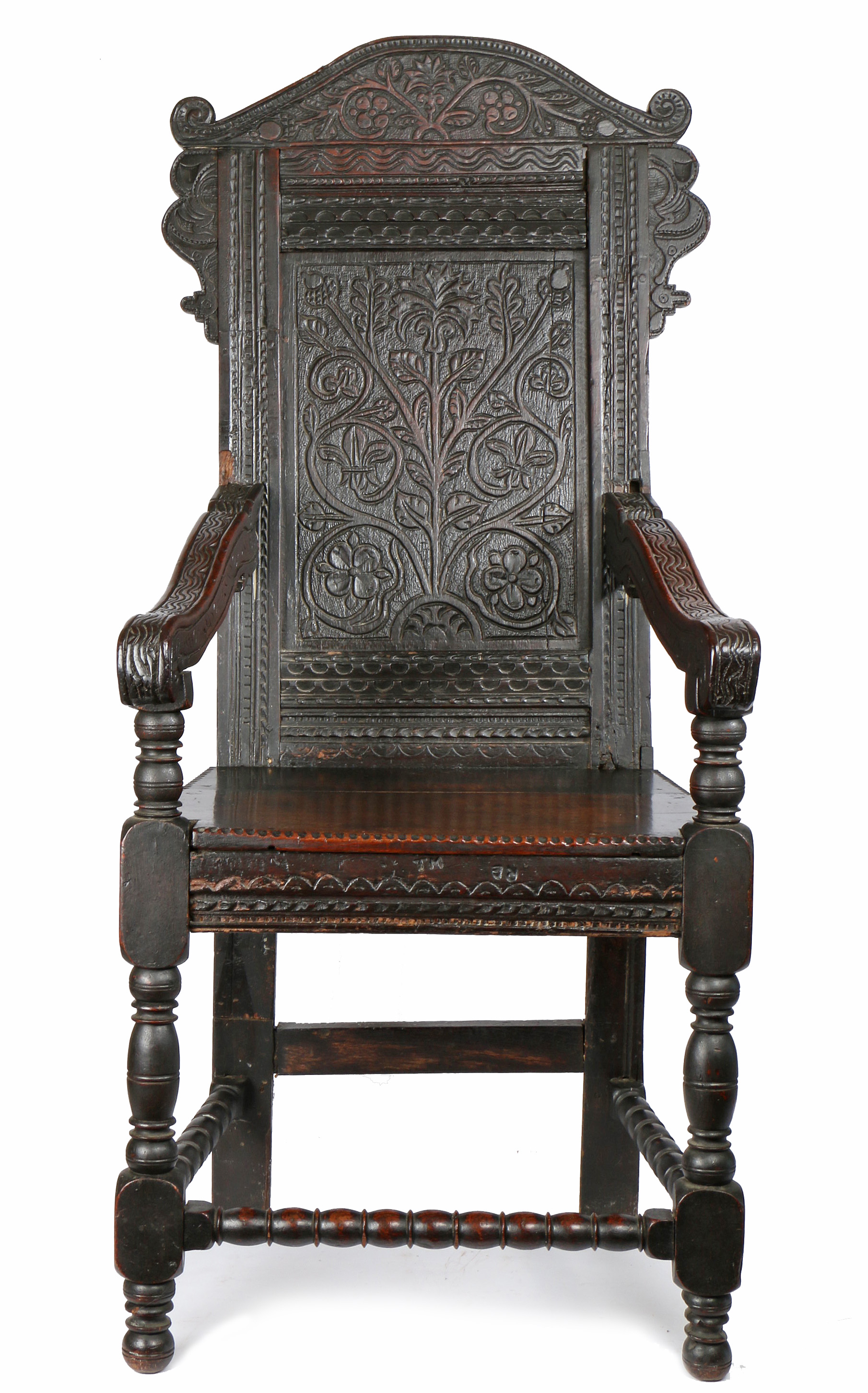 A Charles II oak open armchair, circa 1660 and later The back panel carved with a single flowering