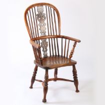 A 19th century yew and elm Windsor armchair, Nottinghamshire, circa 1830 The hooped back with four
