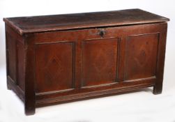 A Charles I oak and inlaid coffer, circa 1630 The boarded top with moulded front and end-cleats, the