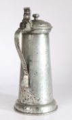 A large James I pewter flagon. circa 1610 Having a plain straight-sided tapering drum, with ovolo