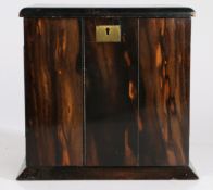 A 19th century coromandel wood cabinet, the rectangular top above two doors raised on a plinth base,