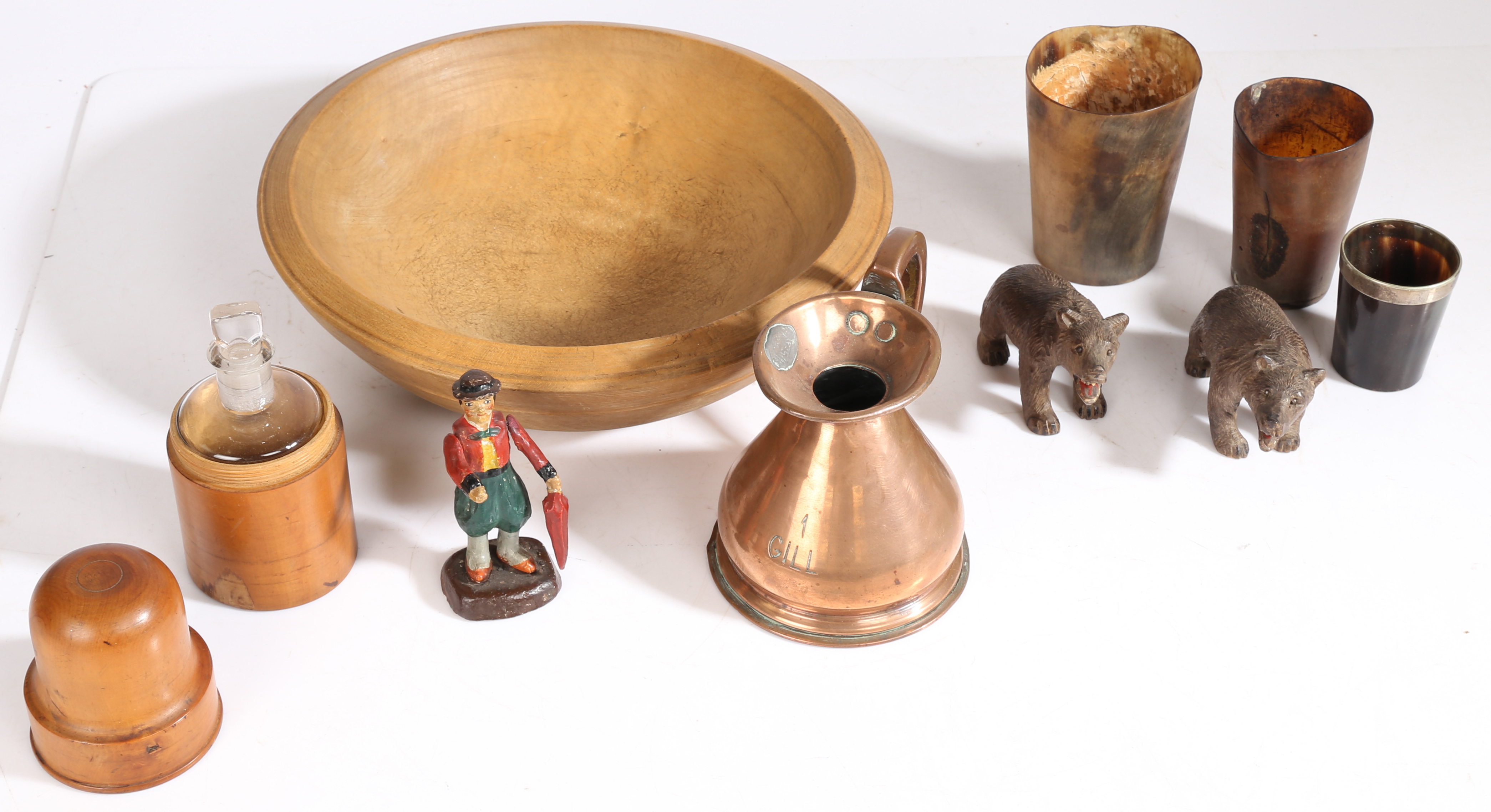 A collection of works of art, to include horn cups, a painted figure, two Black forest bears, a