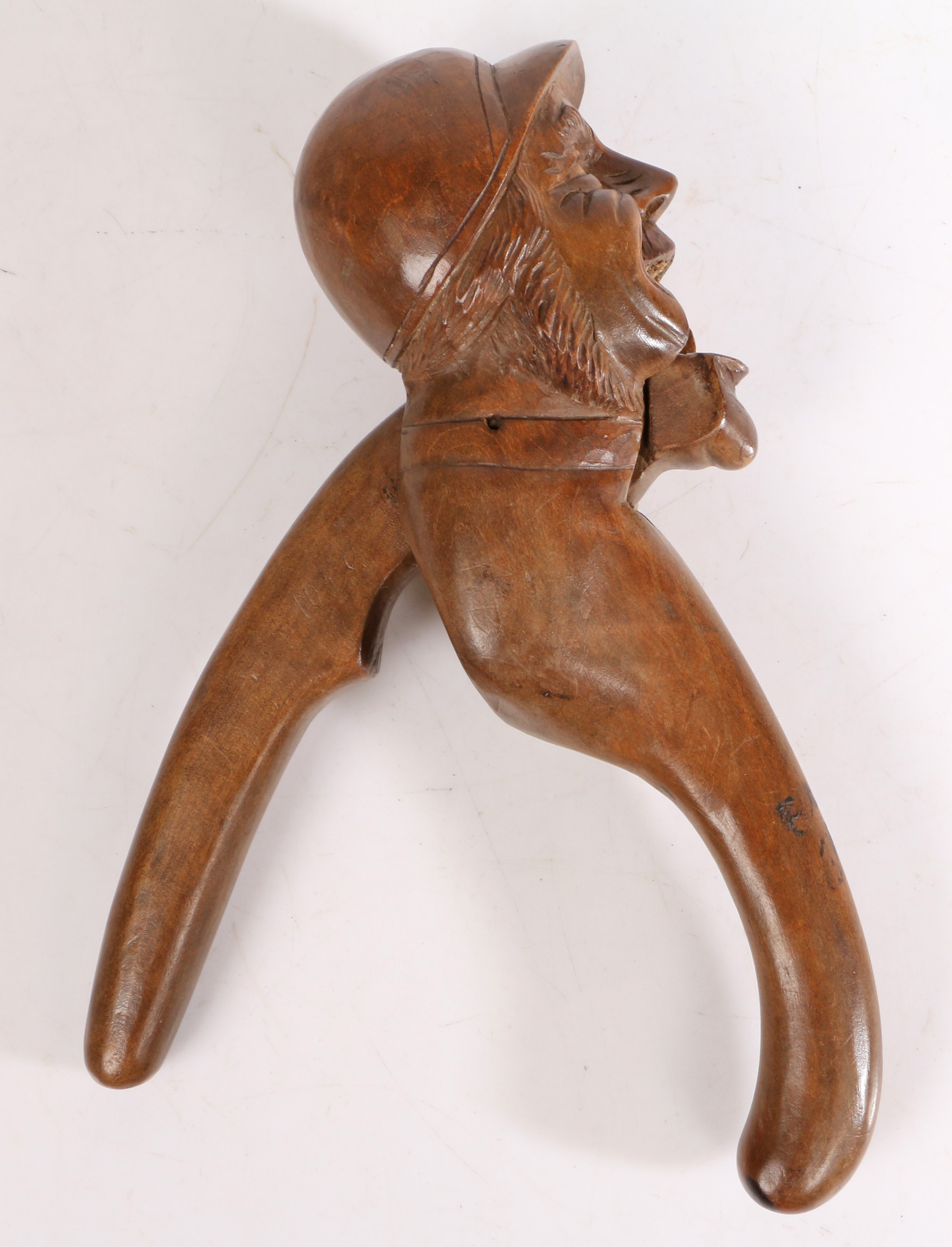A late 19th Century/ early 20th Century Black Forest lever-action nut cracker, carved as a jockey, - Image 2 of 2