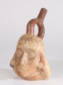 A Peruvian Moche terracotta pottery vessel in the form of a south american man, 24cm high