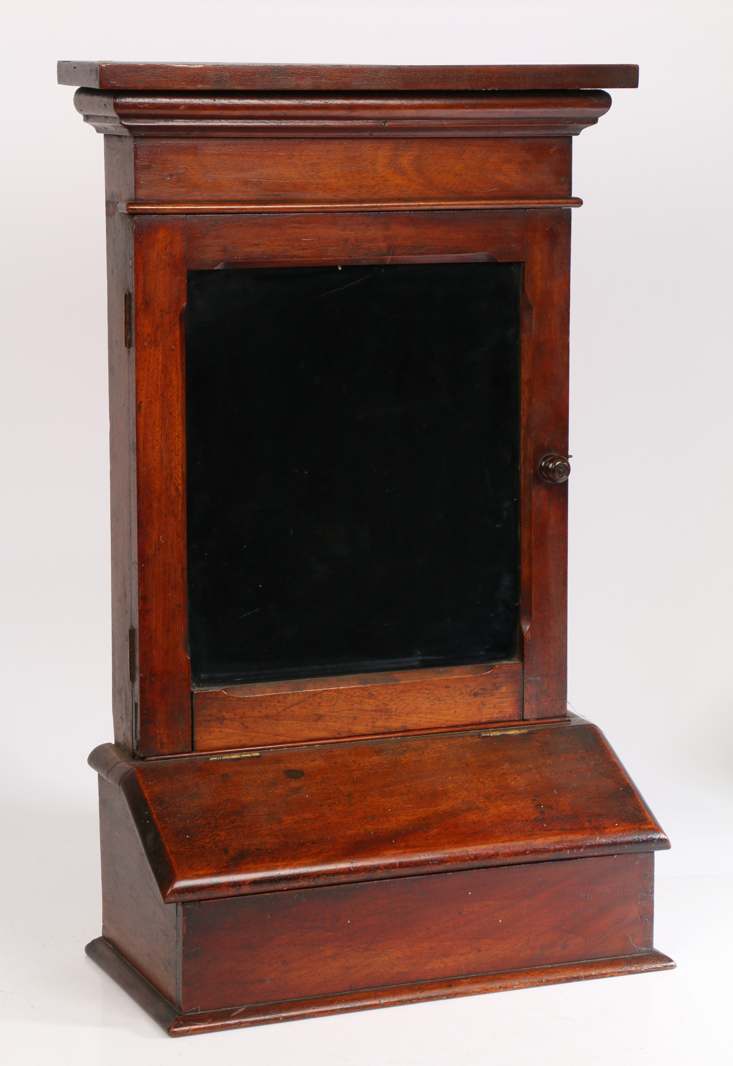 A 19th Century pipe case/ display case, the concave cornice above a glazed door and hinged