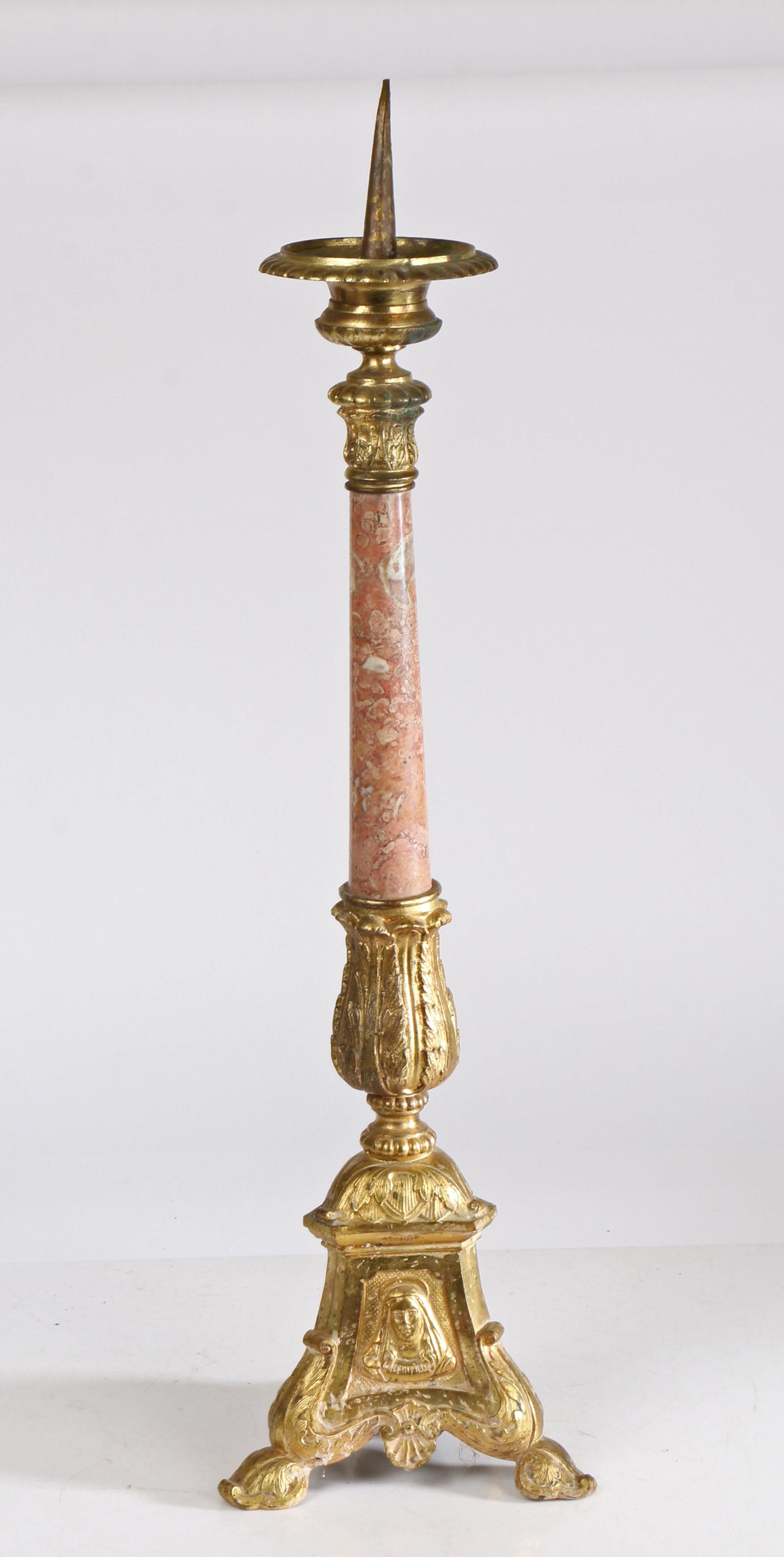 A 18th century style gilt metal pricket candlestick, having a gadrooned flange above a acanthus leaf