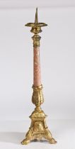 A 18th century style gilt metal pricket candlestick, having a gadrooned flange above a acanthus leaf