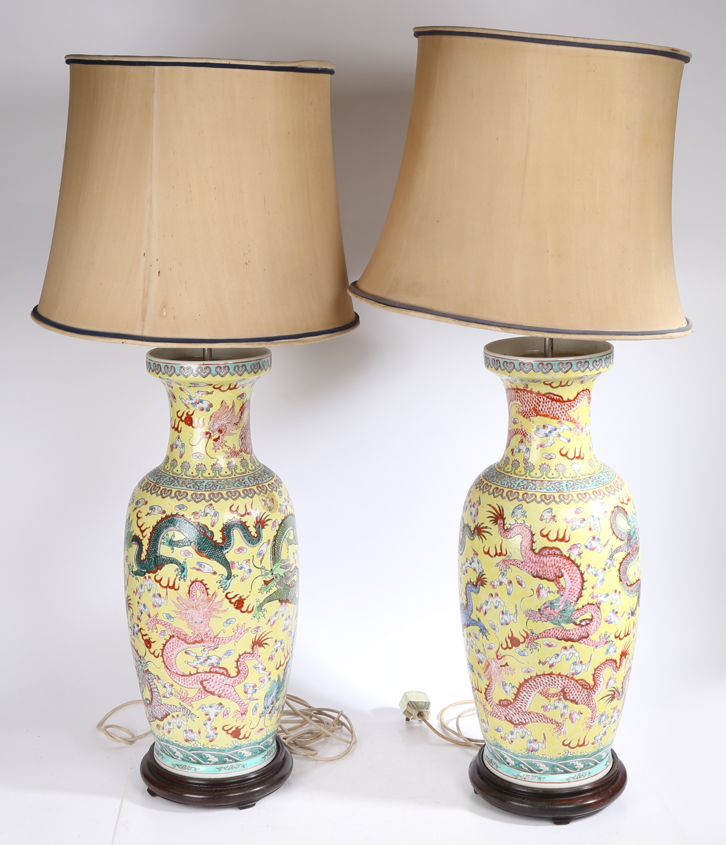 A Large pair of Chinese vases (converted into lamps), 20th century, having a yellow ground decorated