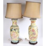 A Large pair of Chinese vases (converted into lamps), 20th century, having a yellow ground decorated