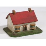 An early 20th Century Folk Art money box, in the form of a cottage with red roof roof and white