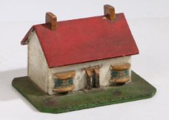 An early 20th Century Folk Art money box, in the form of a cottage with red roof roof and white