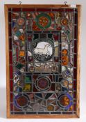 An interesting stained glass window formed of various panels to include 17th century panels which