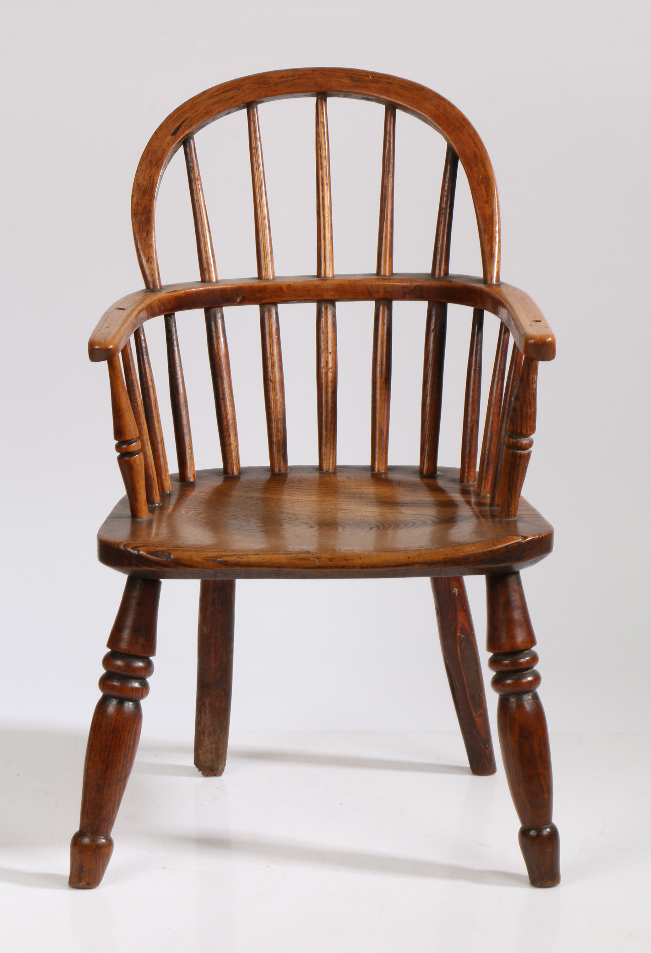 A 19th Century child's ash and oak Windsor armchair, the arched top rail above spindles and a shaped