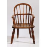 A 19th Century child's ash and oak Windsor armchair, the arched top rail above spindles and a shaped