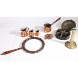 A collection of 19th Century and earlier metalware, to include a candlestick, three copper jugs, a