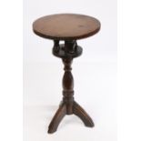 A 19th Century oak birdcage action candle stand, the circular top above three turned finials and a