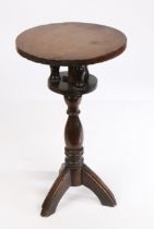 A 19th Century oak birdcage action candle stand, the circular top above three turned finials and a