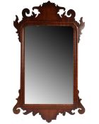 A small George II red walnut wall mirror, the rectangular mirror plate within an arch and swag