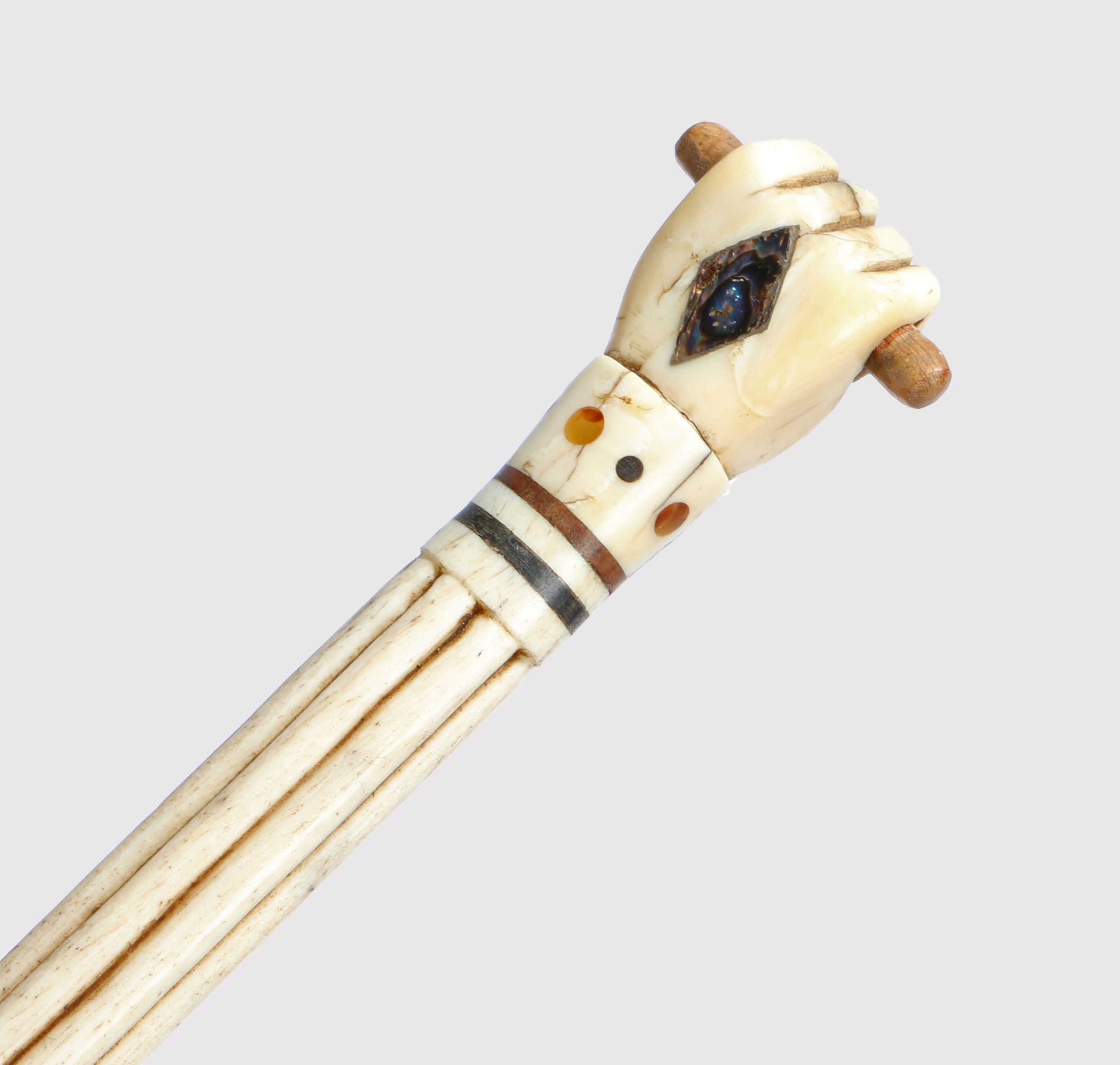 A George III whalebone and baleen walking stick, the handle in the form of a clenched fist holding a