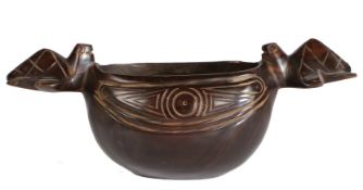 A South Sea hardwood bowl, having two handles in the form of turtles and a carved body, possibly
