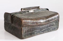 A 19th century crocodile skin vanity case, having a carrying handle to the top, 29cm wide