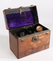 A late 19th/early 20th century leather cased apothecary cabinet, having a tooled leather top opening
