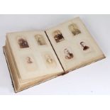 A Victorian Mother of pearl and abalone photograph album, enclosing many Victorian photographs,