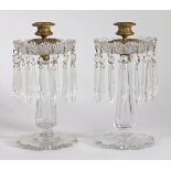 A Pair of Victorian glass table lustres, having a brass candlestick above a cut glass flange with