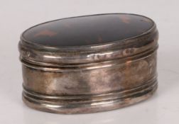 A George V silver and tortoiseshell box, of oval form and having rings to the body, hallmarked