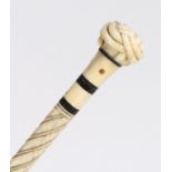 A 19th century whalebone tortoiseshell and inalid walking stick, the handle carved as a trinity knot