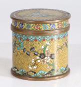 A Chinese Cloisonne enamel cylindrical pot and cover, having a yellow ground set with floral blossom