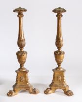 A pair of 19th century Baroque gilt wood lamp bases, having a flared rim above a tapering carved