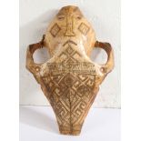 A Late 19th/early 20th century Indonesian Belu-Atoni Timor cow skull mask, having a carved mouth and