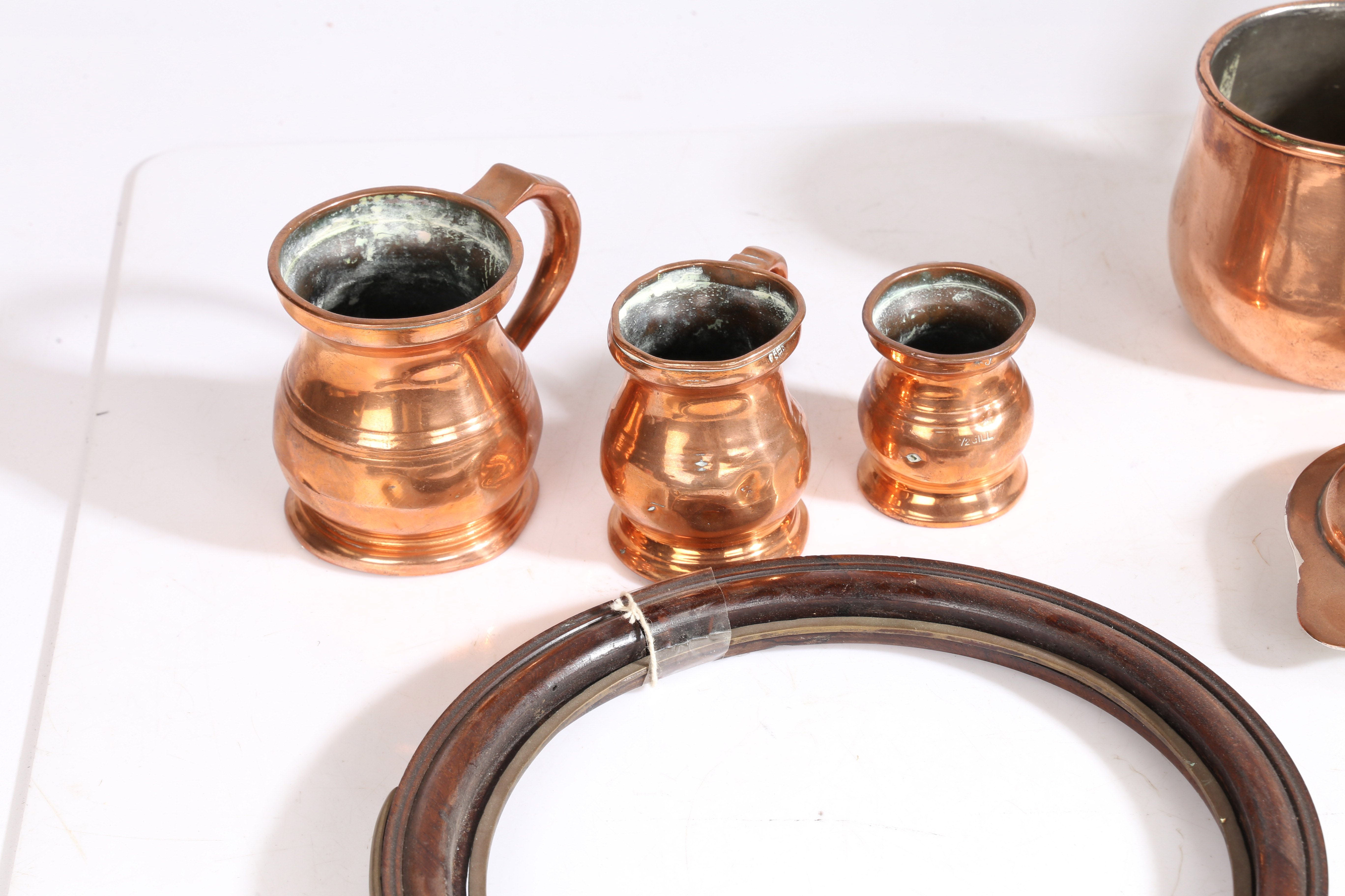 A collection of 19th Century and earlier metalware, to include a candlestick, three copper jugs, a - Bild 2 aus 6