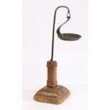 A wrought-iron and timber oil-type lamp, with a hanging pan above a square section column and
