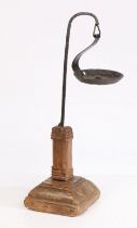 A wrought-iron and timber oil-type lamp, with a hanging pan above a square section column and