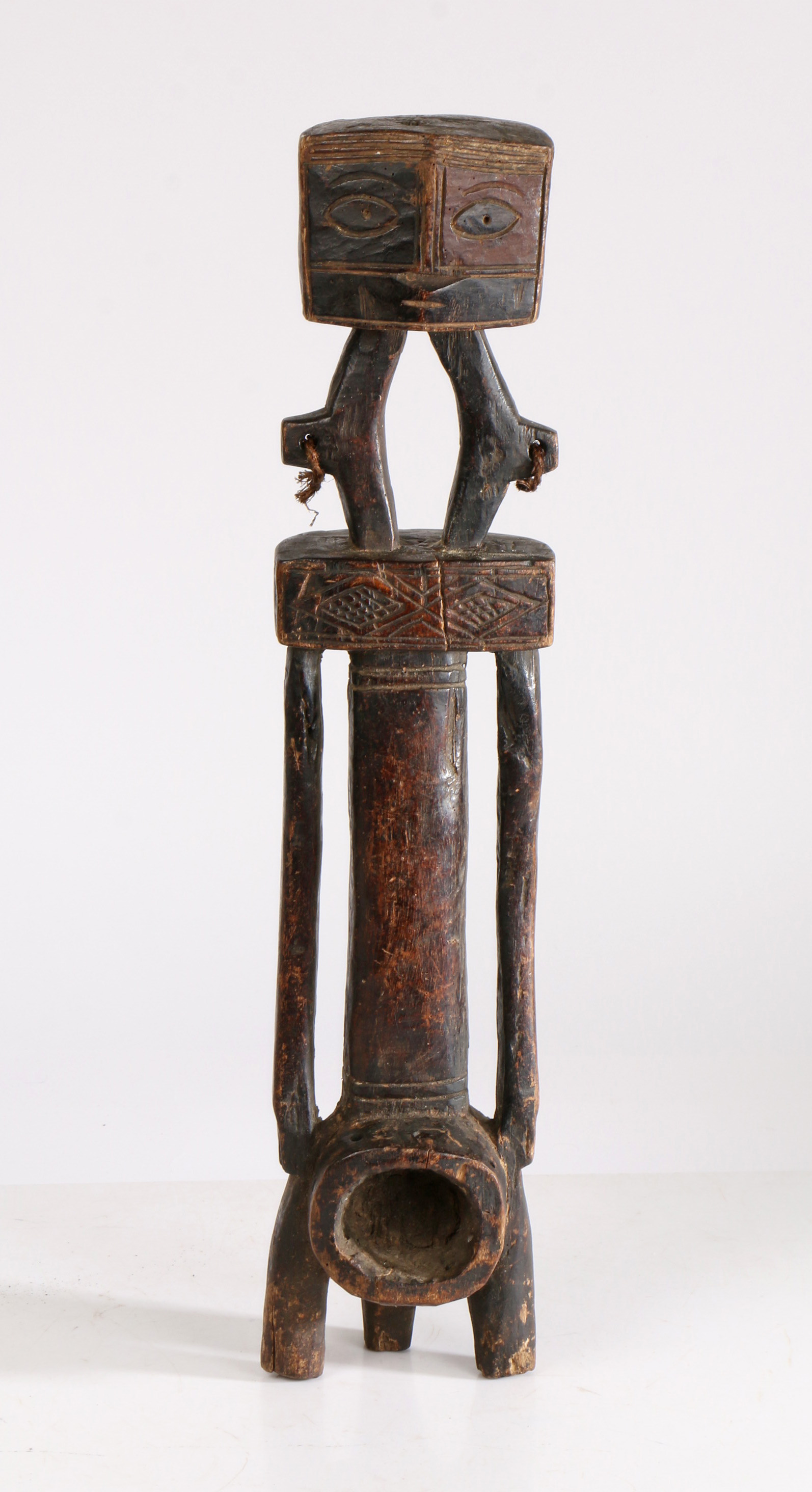 A East African Carved Figure of Ngombe from the Democratic Republic of Congo, having a geometric